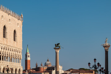 Obraz premium Scenic view of statue of Lion of Venice, Statue of Saint Teodoro of Amaseat and Church of San Giorgio Maggiore in Venice, Veneto, Northern Italy, Europe. Venetian architectural landmarks