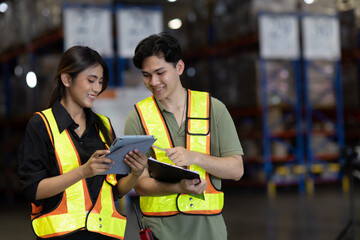 Warehouse worker working in warehouse storage. Foreman or worker work at factory site check up...