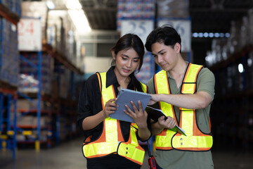 Warehouse worker working in warehouse storage. Foreman or worker work at factory site check up...