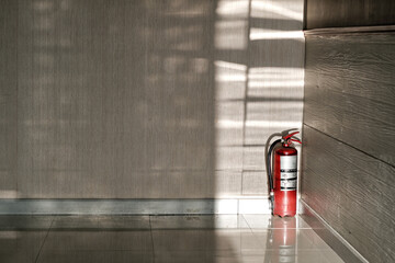 old fire extinguisher put on the conner of the meeting room in the sunshine from out side