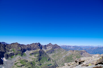 Panoramic view from mountain summit Monte Viso (Monviso) in the Cottian Alps, Cuneo, Piemonte, Italy, Europe. Massive rock walls and ridges of the Stone king. Majestic landscape. Wanderlust, climbing