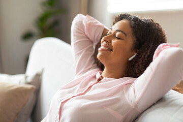 Relaxing African American lady lounging at home