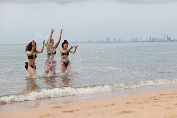 group of happy pretty women in bikinis  Ran up from the sea Holiday Vacation and  having fun