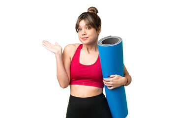 Young sport girl going to yoga classes while holding a mat over isolated chroma key background...