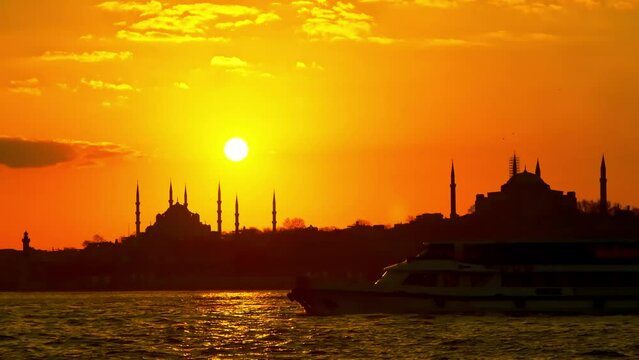 Sunset time silouette of Istanbul. View to Bosphorus. Showing Hagia Sophia and Blue Mosque