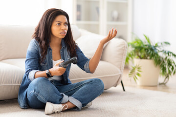 Woman Sitting on Floor Holding Remote Control