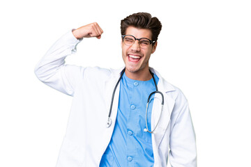 Young doctor man over isolated background doing strong gesture