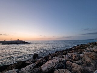 Endless View Of Ocean With Rocks On The Sunset