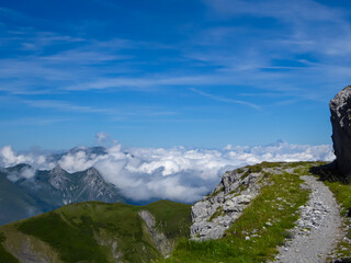 Scenic mtb trail along ancient pathway from the Alps to the sea, through the Italian regions of Piemonte and Liguria, and France. Looking at endless mountain ranges and lush green pastures and hills.