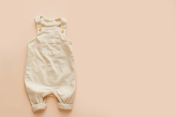 Baby girl clothes on pink pastel background. Fashion newborn clothes. Flat lay, top view. Copy space. Baby kids cotton clothing set. Infant bodysuit made of organic eco friendly cotton. Gender neutral