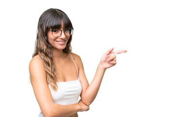 Young caucasian woman over isolated background pointing finger to the side