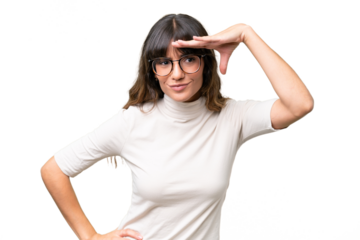 Young caucasian woman over isolated background looking far away with hand to look something
