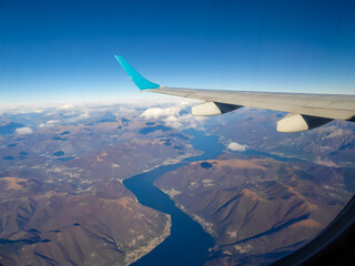 Aerial panoramic view of the Lake Lago di Como and Lago Maggiore seen from a commercial flight. Norther Italy region of Lombardy. The lakes are covered by snow capped mountain peaks of the Alps