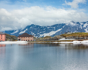 Spring alps mountain lake Lago della Piazza and Alexander Suworow monument in far (Switzerland,...