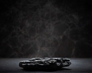 real natural black rock charcoal on dark gray background for podium