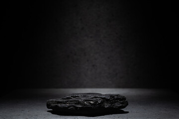 real natural black rock charcoal on dark gray background for podium