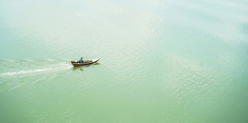 Fisherman riding small traditional fishing boats with equipment in river. Top view, Thailand.