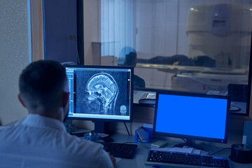doctor diagnoses a person using an MRI machine