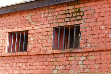 Small windows with bars brick building