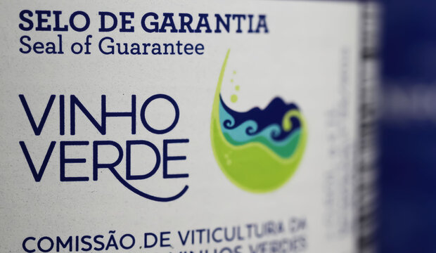 Viersen, Germany - May 9. 2024: Closeup of portuguese quality control guarantee seal on Vinho verde wine bottle (focus left)