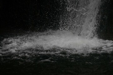 Closeup of waterfall, white water splashing on a black background, Tbilisi, Georgia, botanical...
