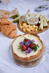 Cake on summer picnic with strawberry and lilac