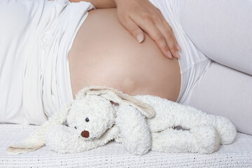 Happy pregnant girl lies on white background - 791037672