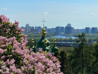 Draagtas Ukraine Kyiv city, scenic cityscape through lilac park. © OLENA