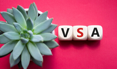 VSA - Volume Spread Analysis symbol. Wooden cubes with word VSA. Beautiful red background with...