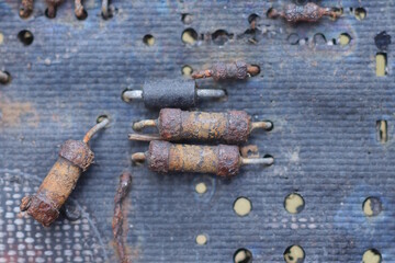 part of an old black microcircuit with brown small resistors and transistors