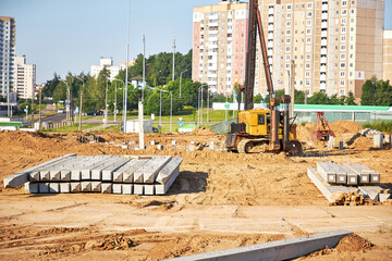 Construction site.Equipment for installing piles in the ground, a heavy machine for driving pillars work when laying the foundation of the building.