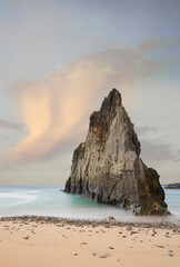 Mexota beach rock at sunrise with rising tide, Asturias