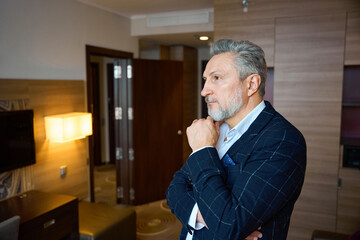 Side view of adult caucasian businessman wearing suit thinking about something - Powered by Adobe