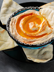 Chickpea Hummus Bowl with Pita Chips and Paprika, Close-up