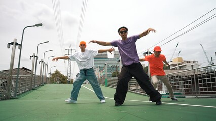Group of professional break dancer dancing together or moving to hip hop music. Low angle camera of...