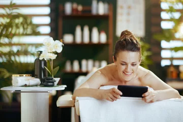 Foto op Plexiglas smiling modern woman in massage cabinet laying on massage table © Alliance