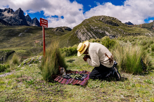 Andean man performing ritual of payment to the land in Peru, payment to the Pachamama