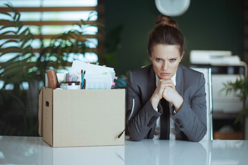 stressed modern woman worker in modern green office