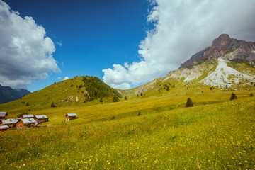 landscape with mountains, hills, clouds and meadow