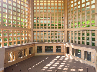 Latticework gazebo with morning sunlight and shadows in an ornamental garden in west central...