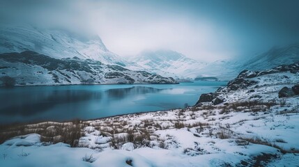 Fototapeta na wymiar Snowy mountains and lake in winter landscape