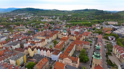 Bird's-eye view captures Jelenia Góra's bustling market square and 18th-century town hall.