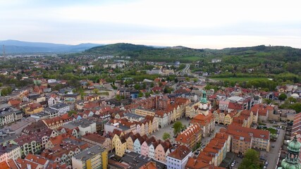 Aerial perspective reveals Jelenia Góra's vibrant marketplace and elegant town hall.