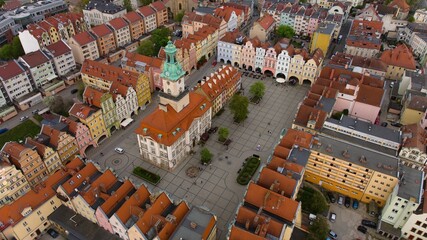 Overhead shot displays Jelenia Góra's lively market square and magnificent 18th-century town hall. - obrazy, fototapety, plakaty