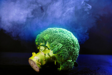 green broccoli photographed on a black background