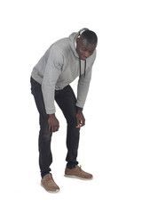 side view of a man crouched down and looking the floor on white background