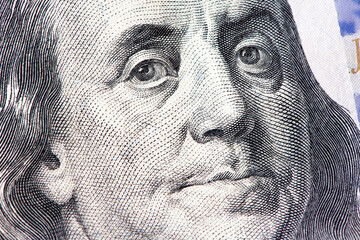 Benjamin Franklin close up face from us hundred dollar bill. United States national currency banknote fragment