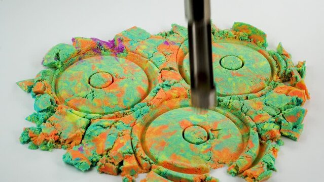 Very Satisfying and Relaxing Kinetic Sand ASMR. Cutting anti stress macro close up colorful Kinetic Sand with a Knife. Kinetic sand cutting with a knife on a black background. ASMR .