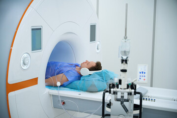 Patient undergoing magnetic resonance imaging examination with contrast