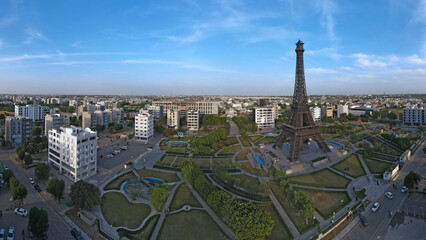 An aerial panorama of Eiffel Tower's replica, located in Lahore's Bahria Town and captured at dusk. 